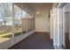 Spacious screened porch with ceiling fan, offering an enjoyable view of the outdoor landscape at 717 Lighthouse Dr, Tarpon Springs, FL 34689