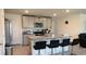 Modern kitchen with granite countertops, stainless steel appliances, and bar stool seating at the island at 7530 Broad Pointe Dr, Zephyrhills, FL 33540