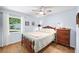 Cozy bedroom with a large window and hardwood floors at 809 Butch Cassidy Trl, Wimauma, FL 33598