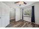 This bedroom has wood-look floors and a view of the yard through the window at 8111 Country Club N Rd, St Petersburg, FL 33710