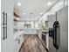 Modern kitchen with stainless steel appliances, white cabinets, and sleek countertops at 8111 Country Club N Rd, St Petersburg, FL 33710