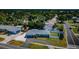 Aerial view of a well-maintained home with a circular driveway, white gravel, and a spacious backyard at 8201 Ridge Rd, Seminole, FL 33772