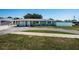 Charming single-story home with a well-manicured lawn and a driveway leading to the garage at 8201 Ridge Rd, Seminole, FL 33772