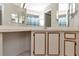 Bright bathroom featuring a long vanity with ample storage space and large mirrors at 8206 Leafy Ct, Port Richey, FL 34668