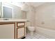 Bathroom with neutral tile, a vanity, and a combined shower and tub at 8206 Leafy Ct, Port Richey, FL 34668