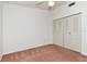 Cozy bedroom featuring carpeted floor, ceiling fan, and closet at 8206 Leafy Ct, Port Richey, FL 34668