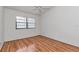 Bedroom featuring wood floor, ceiling fan, and large window at 8206 Leafy Ct, Port Richey, FL 34668