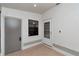 Entryway featuring tile flooring, a window, and access doors to the interior and exterior at 8206 Leafy Ct, Port Richey, FL 34668