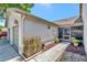 Charming home entrance with a screened porch, manicured plants, and a welcoming walkway at 8206 Leafy Ct, Port Richey, FL 34668