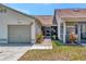 Charming home featuring an attached garage, cozy screened porch, and neatly manicured landscaping at 8206 Leafy Ct, Port Richey, FL 34668
