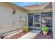 Close up of a charming home entrance with a screened porch and manicured plants at 8206 Leafy Ct, Port Richey, FL 34668