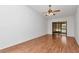 Living room with hardwood floor, ceiling fan and sliding glass door at 8206 Leafy Ct, Port Richey, FL 34668