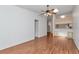 Living room with hardwood floors, ceiling fan and access to the kitchen at 8206 Leafy Ct, Port Richey, FL 34668