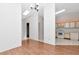 Open-concept living area featuring hardwood floors, a skylight, and a seamless transition to the kitchen at 8206 Leafy Ct, Port Richey, FL 34668