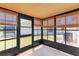 Enclosed sunroom showcasing tile flooring, and multiple windows at 8206 Leafy Ct, Port Richey, FL 34668