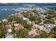 Wide aerial view of a tree-filled neighborhood near the water with homes of various sizes at 8326 40Th N Pl, St Petersburg, FL 33709