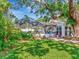 Expansive backyard with lush greenery, screened pool enclosure, and a cozy patio at 8326 40Th N Pl, St Petersburg, FL 33709