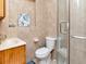 Compact bathroom featuring a tiled shower, modern sink and fixtures, and beach-themed artwork at 8326 40Th N Pl, St Petersburg, FL 33709