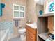 Well-lit bathroom with earth-toned tiles, modern fixtures, and blue accents at 8326 40Th N Pl, St Petersburg, FL 33709