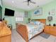Comfortable bedroom with seafoam green walls, tile floors, and wooden furniture at 8326 40Th N Pl, St Petersburg, FL 33709