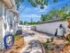 Spacious driveway and yard area with a white privacy fence at 8326 40Th N Pl, St Petersburg, FL 33709
