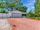 Charming home featuring a brick paved driveway, lush lawn, and a two-car garage at 8326 40Th N Pl, St Petersburg, FL 33709