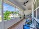 Relaxing screened-in porch with comfortable seating, ceiling fan, and lovely outdoor views at 8326 40Th N Pl, St Petersburg, FL 33709