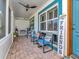 Cozy screened-in porch with comfortable seating, ceiling fan, and charming decor at 8326 40Th N Pl, St Petersburg, FL 33709