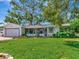 Single-story home featuring a well-maintained lawn, screened-in porch, and attached two-car garage at 8326 40Th N Pl, St Petersburg, FL 33709