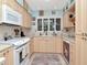 Efficient kitchen with white appliances, ample cabinet space, and a window providing natural light at 8326 40Th N Pl, St Petersburg, FL 33709