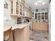 Well-lit kitchen with light wood cabinets, modern appliances, and tiled countertops at 8326 40Th N Pl, St Petersburg, FL 33709