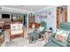 Bright living room featuring coastal decor, comfortable seating, and an open layout with access to outdoor living spaces at 8326 40Th N Pl, St Petersburg, FL 33709