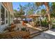 Inviting backyard deck with dining and relaxing areas surrounded by lush tropical foliage at 8403 W Gulf Blvd, Treasure Island, FL 33706
