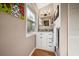 Bathroom featuring a vanity with granite countertop, decorative mirror, and ample natural light at 8403 W Gulf Blvd, Treasure Island, FL 33706