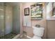 Charming bathroom with a glass door shower and decorative wall art and fixtures at 8403 W Gulf Blvd, Treasure Island, FL 33706