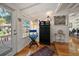 Inviting entryway with a stained glass window, hardwood floors, and unique decor at 8403 W Gulf Blvd, Treasure Island, FL 33706