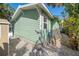 Exterior corner of home with vinyl siding, lattice skirting, and an air conditioning unit at 8403 W Gulf Blvd, Treasure Island, FL 33706