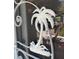 Decorative white palm tree design on the white metal security screen door, enhancing curb appeal at 8403 W Gulf Blvd, Treasure Island, FL 33706