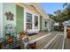 Close-up of the front porch featuring decor, french doors and potted plants at 8403 W Gulf Blvd, Treasure Island, FL 33706