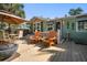 Relaxing front porch with Adirondack chairs, table and fire pit, ideal for seaside relaxation at 8403 W Gulf Blvd, Treasure Island, FL 33706