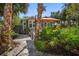 Charming home nestled among lush tropical landscaping with a sunny front porch and inviting entryway at 8403 W Gulf Blvd, Treasure Island, FL 33706