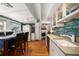 Open kitchen featuring granite counters, stainless appliances, and eat-in dining at 8403 W Gulf Blvd, Treasure Island, FL 33706