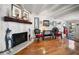 Cozy living room featuring a stone fireplace, wood mantle, and hardwood floors at 8403 W Gulf Blvd, Treasure Island, FL 33706