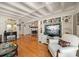 Bright living room features white coffered ceilings, hardwood floors, and access to fireplace at 8403 W Gulf Blvd, Treasure Island, FL 33706