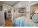 Comfortable bedroom featuring a ceiling fan, wood floors, and a view of the entryway at 8403 W Gulf Blvd, Treasure Island, FL 33706