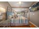 Comfortable bedroom featuring a ceiling fan, wood floors, and a wall-mounted television at 8403 W Gulf Blvd, Treasure Island, FL 33706