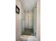 Modern shower enclosure with clear glass doors and decorative stone floor at 8403 W Gulf Blvd, Treasure Island, FL 33706