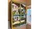 Colorful wall art depicting a house, enhancing the bathroom's playful charm at 8403 W Gulf Blvd, Treasure Island, FL 33706