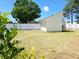 Fenced backyard featuring a home exterior showcasing the architecture and landscaping at 8719 Sunlit Cove Ne Dr, St Petersburg, FL 33702