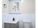Renovated bathroom featuring gray vanity, white tile backsplash, and modern fixtures at 8719 Sunlit Cove Ne Dr, St Petersburg, FL 33702